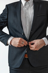 Man in dark suit two buttons, doing button