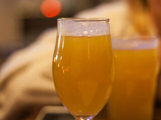 Closeup on a beer mug containing a wheat beer, weissenbier style, served in a standard pint size glass