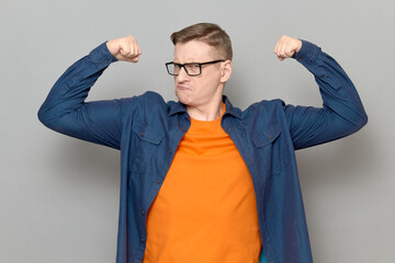 Portrait of rebellious proud mature man raising clenched fists up