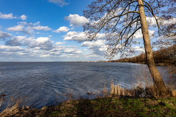 sunny and cloudy day on a lake in spring
