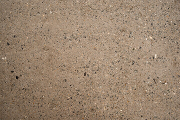 The texture of a concrete wall with stone chips. External part of the building.
