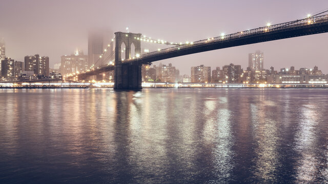 Brooklyn Bridge on a foggy night, color toned picture, New York City, USA. © MaciejBledowski