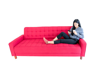 Obraz premium Asian pretty woman are sitting relaxation, Using a mobile phone and holding a coffee cup on the red sofa On white isolated background, to people concept.