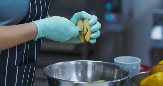 Woman scooping fruit seeds before cooking pie