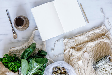 Stylish composition on the marble table with notes, zero waste neutral bags, seeds, eggs, bio...