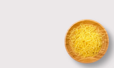 Pasta in a wooden bowl on a white background