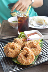 Fried shrimp cake, served on black dish in restaurant. Thailand foods.