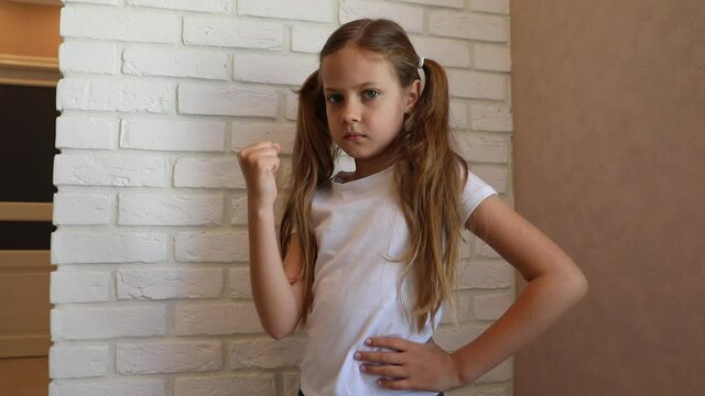 little offended girl shaking her fist. the little girl is angry