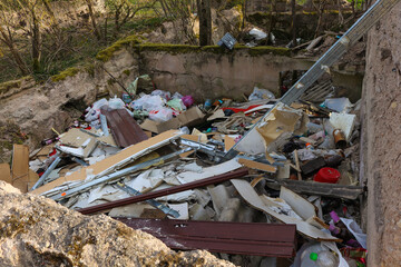 Pile of garbage thrown up next to the forest