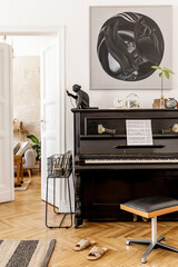 Fototapeta na wymiar Stylish and cozy interior of living room with black piano, furniture, plant, wooden clock, lamp, mock up painitngs, carpet, decoration and elegant personal accessories in modern home decor.