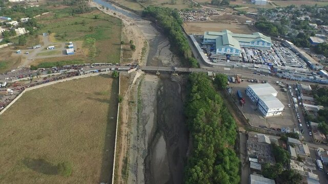 Aerial view above Dajabon bridge and market at border with Haiti