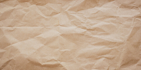Crumpled brown paper texture, background. Messy wrinkled parchment pattern. Craft rustic sheet, old wrapping card.