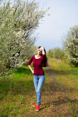 Brown hair girl in sunglasses on the flower meadow