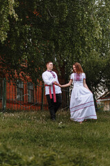Naklejka na ściany i meble A couple in love in Russian traditional dresses