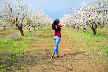 Brown hair girl in sunglasses on the flower meadow