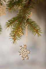 Wooden beautiful decoration on the spruce. Traditional classic wooden Christmas toys
