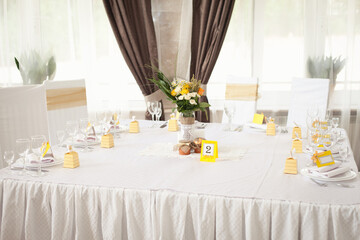 Restaurant Served table, interior in white colors with yellow accents