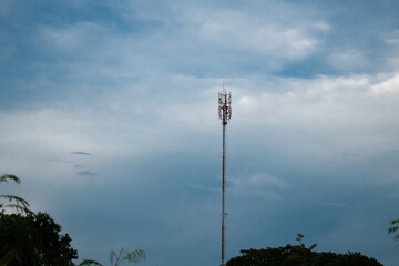 telephone antena green field and blue sky with white clouds