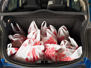 Trunk full of plastic bags from a supermarket. Poly pouches from a grocery store in the rear boot...