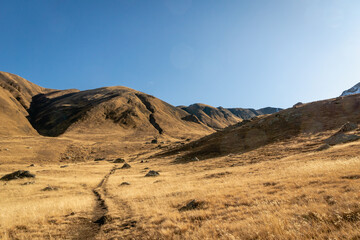 dramatic mountain hiking landscape in Juta trekking area landscape in autumn -  popular trekking  in the Caucasus mountains, Kazbegi region, Georgia.