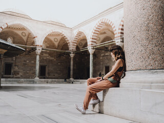 Woman sitting in a mosque in Istanbul, Turkey