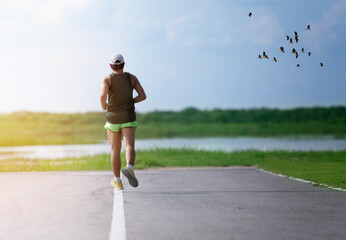 one man running on the street with beautiful sky background