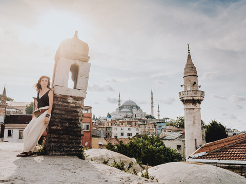 Young woman with the background of the Istanbul panorama at sunset