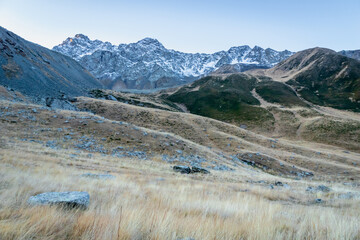 Fototapeta na wymiar dramatic mountain landscape in Juta trekking area landscape with snowy mountains at dawn - popular trekking in the Caucasus mountains, Kazbegi region, Georgia.