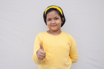 Portrait Of Girl giving thumbs up
