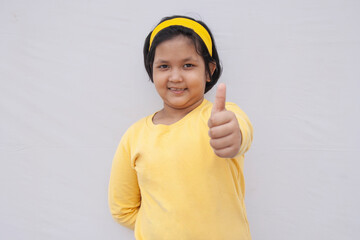 Portrait Of Girl giving thumbs up
