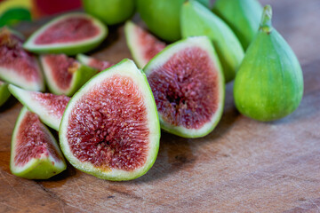 Fig - fresh figs and sliced fig fruits close-up showing texture on cutting board