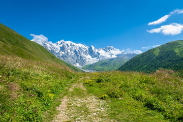 Svaneti landscape with glacier and snow-capped mountain in the back near Mestia village in Svaneti region, Georgia.