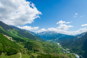 Fototapeta na wymiar Svaneti mountain and village landscape at the trekking and hiking route near Mestia village in Svaneti region, UNESCO heritage area in Georgia.