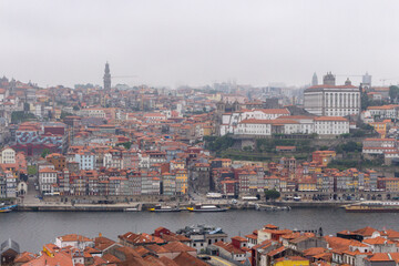Fototapeta na wymiar Colorful houses of Porto Ribeira, traditional facades, old multi-colored houses with red roof tiles on the embankment in the city of Porto. Unesco World Heritage site, Portugal.