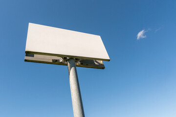 Blank billboard or signpost against blue sky