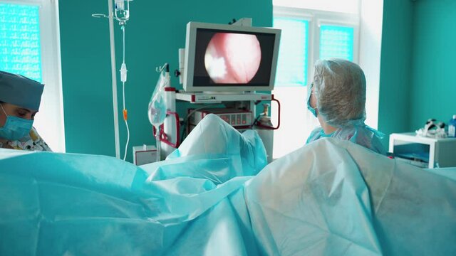 Gynecologist examining patient. Female doctors professional gynecologist examining patient on gynecological chair