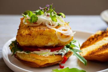 Turmeric fish burger in brioche bun