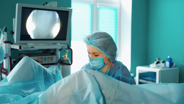Female gynecologist working with patient. Female doctor performing gynecological operation at the hospital