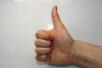 Man's hand in the natural "thumb's up" position.