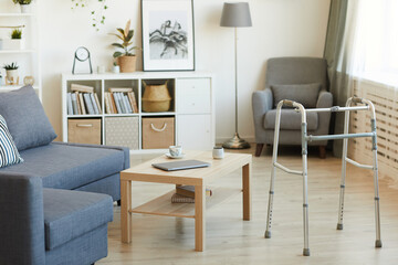 Image of empty domestic living room with walker for senior people - obrazy, fototapety, plakaty