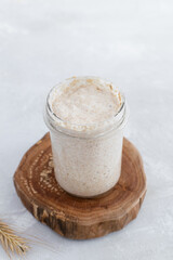 Close-up of jar with natural homemade sourdough levain starter for homemade bakery