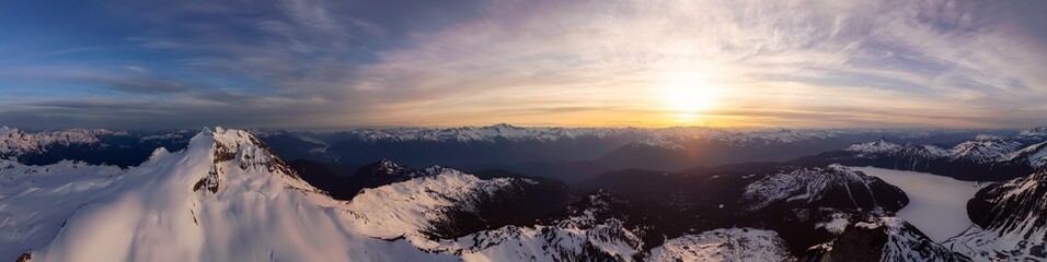 Naklejka na ściany i meble Aerial Panoramic View of Canadian Mountain Landscape during a colorful sunset. Taken in Garibaldi, near Whistler and Squamish, North of Vancouver, British Columbia, Canada. Nature Background Panorama