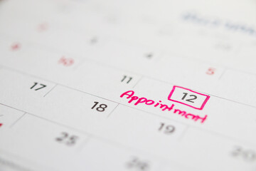 important appointment schedule write on white calendar page date close up