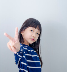 Portrait of young Asian girl kid on white background thinking of new ideas, day dreaming, acting like a smart genius.