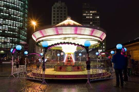 BERLIN - DECEMBER 10, 2013: Children's Carousel at the Christmas market at Potsdamer Platz. Potsdamer Platz is an important public square and traffic intersection in the centre of Berlin.