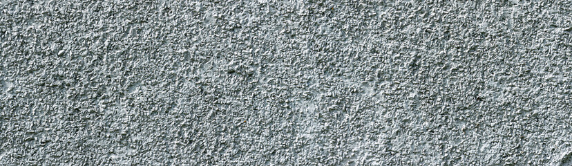 Panorama Roughly plastered wall. The surface of the wall of the facade of the building.