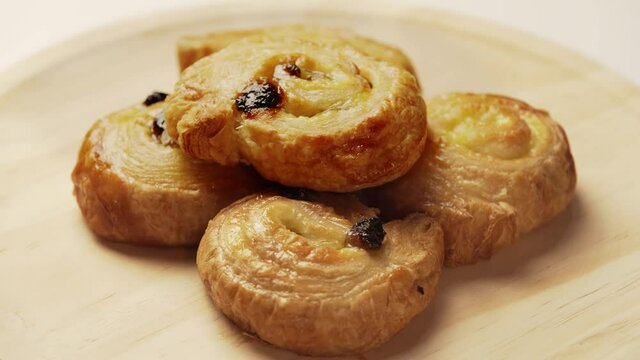 Freshly made homemade pastries on wooden plate overhead view