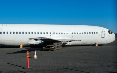 Economic crisis. Disassembled airplane at the airport parking.