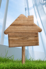 Maison à vendre, maison en bois sur fond herbe et ciel bleu, avec espace pour du texte.