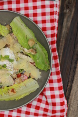 Food photography. Fresh vegetable salad, chicken, eggs with a delicious sprinkling of spices on a wooden table background and napkin decorations. Top view